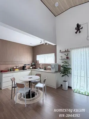 a kitchen with a table and chairs in a room at Stylish Landed Stay in Kulim