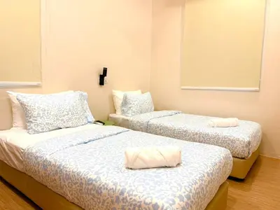 two beds sitting in a room with at Kamar Kita Mūslim-friendly at 11 Victoria in George Town