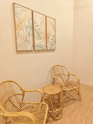 three rattan chairs and a table in a room at Kamar Kita Mūslim-friendly at 11 Victoria in George Town