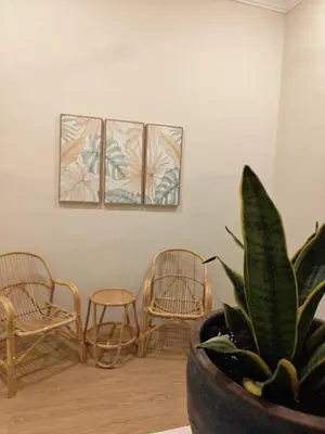 a room with two chairs and a potted plant at Kamar Kita Mūslim-friendly at 11 Victoria in George Town