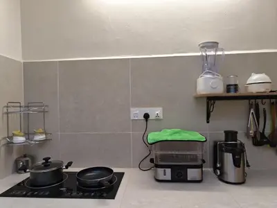 a kitchen with a stove with pots and pans on it at Kamar Kita Mūslim-friendly at 11 Victoria in George Town