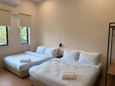 a bedroom with two beds with pillows at Kamar Kita Mūslim-friendly at 11 Victoria in George Town