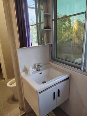 a bathroom with a sink and a window and a toilet at Jed Lifestyle Studio in Kepala Batas