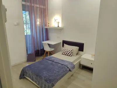 a bedroom with a bed and a desk and a window at Jed Lifestyle Studio in Kepala Batas