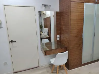 a bathroom with a white chair and a mirror at Jed Lifestyle Studio in Kepala Batas