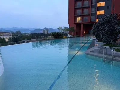 a large swimming pool in front of a building at The Minty Nest - Piccadilly Residence Ipoh with Infinity Pool in Ipoh