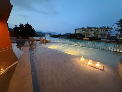 a swimming pool with candles in the water at The Minty Nest - Piccadilly Residence Ipoh with Infinity Pool in Ipoh