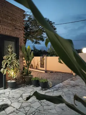 a patio with potted plants and a fence at Morikoi Cottage in Ipoh