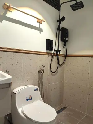 a bathroom with a toilet with a camera on the wall at Morikoi Cottage in Ipoh