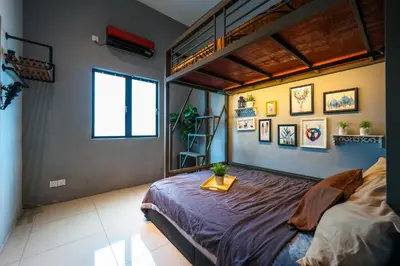 a bedroom with a bed and a loft bed at 32 cozy stay Projector, Karaoke , BBQ, 7 carpark in Ipoh