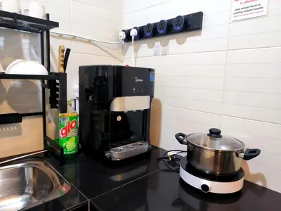 a coffee maker sitting on a counter next to a stove at 32 cozy stay Projector, Karaoke , BBQ, 7 carpark in Ipoh