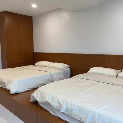 two beds in a room with white sheets at pangkor ocean lot10 in Pangkor
