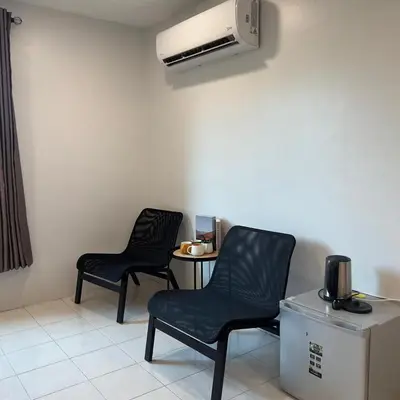 two chairs and a table in a room with a heater at pangkor ocean lot10 in Pangkor