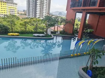 a swimming pool with a slide in a building at IPOH Piccadilly Cozy unit with City View in Ipoh