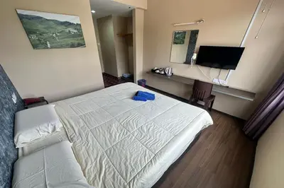 a hotel room with a bed and a desk at Hotel Titiwangsa in Gua Sai