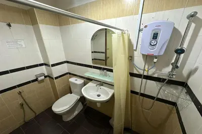 a small bathroom with a toilet and a sink at Hotel Titiwangsa in Gua Sai