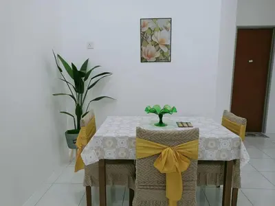 a dining room table with a yellow bow on it at Kota Emas Homestay -in Sarang Semut, Kedah in Gua Sai