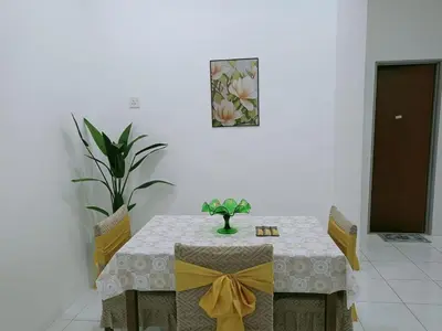 a dining room table with a yellow bow on it at Kota Emas Homestay -in Sarang Semut, Kedah in Gua Sai