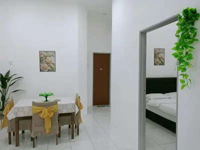 a dining room with a table with a yellow bow on it at Kota Emas Homestay -in Sarang Semut, Kedah in Gua Sai