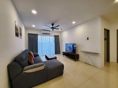 a living room with a couch and a flat screen tv at Ipoh Manhattan Condo, Pengkalan 4br12pax in Ipoh