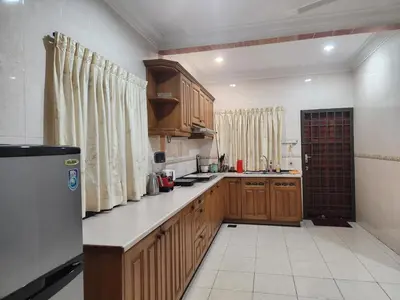 a kitchen with wooden cabinets and a counter top at Ipoh sunway lostworld 5br 15pax in Tambun