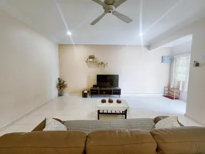 a living room with a couch and a flat screen tv at Ipoh sunway lostworld 5br 15pax in Tambun
