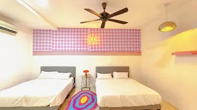 a room with two beds and a ceiling fan at IPOH PRIVATE POOL VILLA 6BR 23pax in Ipoh