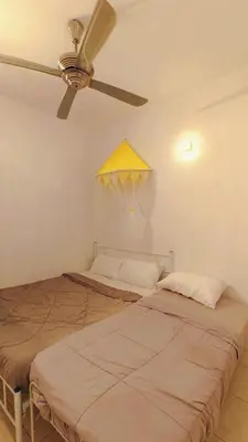 two beds in a room with a ceiling fan at IPOH PRIVATE POOL VILLA 6BR 23pax in Ipoh