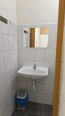 a bathroom with a sink and a toilet at POLI Homes in George Town