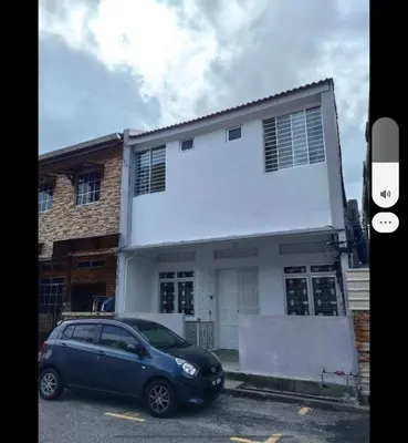 a blue car parked in front of a house at POLI Homes in George Town