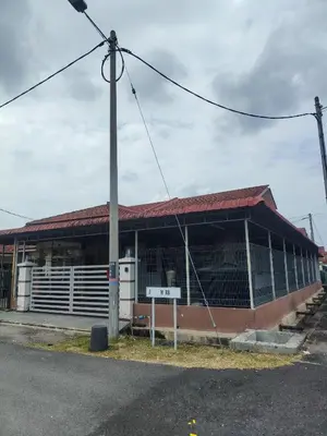 a building with a pole in front of it at Cozy Corner Homestay Bandar Utama Gua Musang in Gua Musang