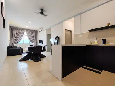 a kitchen and living room with a table and chairs at BW Urban Stay in Ipoh