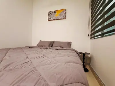 a bed in a bedroom with a picture on the wall at BW Urban Stay in Ipoh