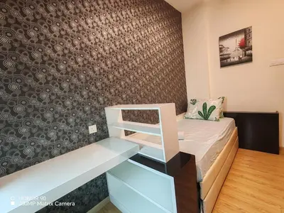 a small room with a bed and a wall at Sky Garden Luxury Family Stay in Ipoh