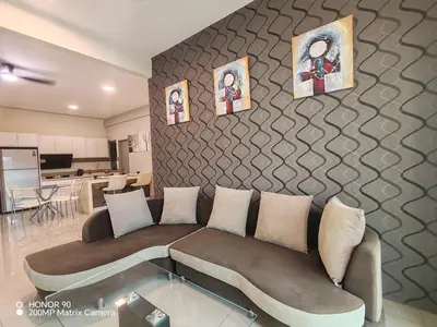 a living room with a couch and pictures on the wall at Sky Garden Luxury Family Stay in Ipoh