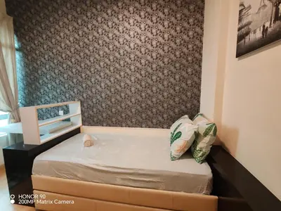 a small bed in a room with a wall at Sky Garden Luxury Family Stay in Ipoh