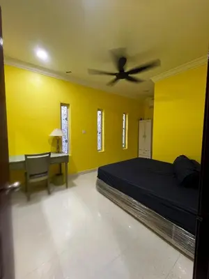 a bedroom with a bed and a ceiling fan at Teratak Minda Cerdas in Kulim