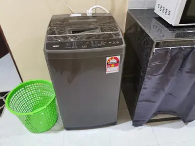 a trash can sitting next to a counter with a green basket at Teratak Minda Cerdas in Kulim