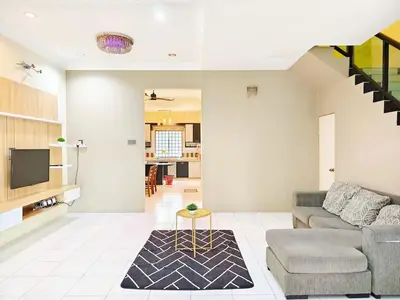 a living room with a couch and a table at ipoh botani 4br12pax pets friendly muji luxe in Ipoh