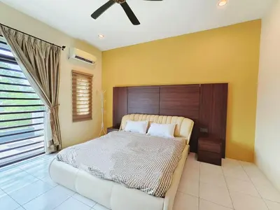 a bedroom with a large bed with a wooden headboard at ipoh botani 4br12pax pets friendly muji luxe in Ipoh