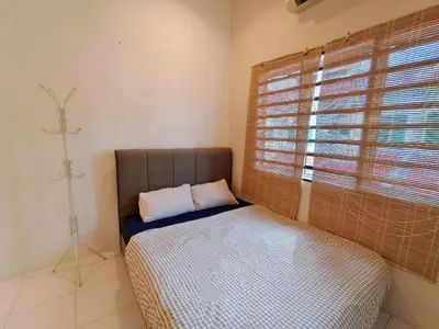 a bed sitting in a room with a window at ipoh botani 4br12pax pets friendly muji luxe in Ipoh