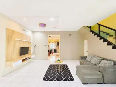 a living room with a couch and a tv at ipoh botani 4br12pax pets friendly muji luxe in Ipoh