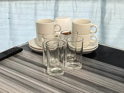 a group of glasses and cups on a table at Mountain View Sameer Glamping in Cameron Highlands