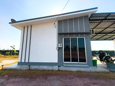 a small house with a large window at White House Villa in Sekincan