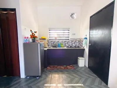 a kitchen with a sink and a counter top at White House Villa in Sekincan