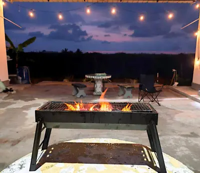 a fire pit in a patio at night at White House Villa in Sekincan