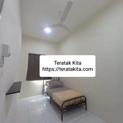 a bed in a room with a sign on the wall at Homestay Teratak Kita in Behrang Hulu