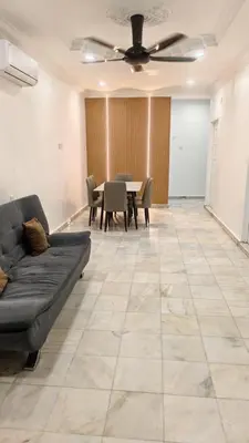 a living room with a couch and a table at DouDou's House in Simpang Ampat