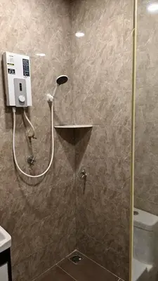 a shower in a bathroom with a glass door at DouDou's House in Simpang Ampat