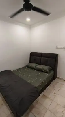 a black bed in a room with a ceiling fan at DouDou's House in Simpang Ampat